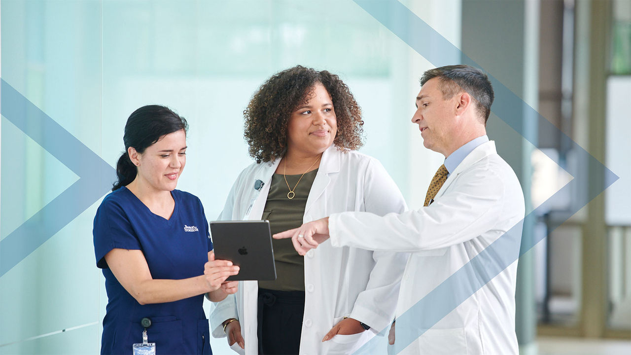 Physician talking with staff representing the business models BodyGuardian has to make things easier for HCPs.